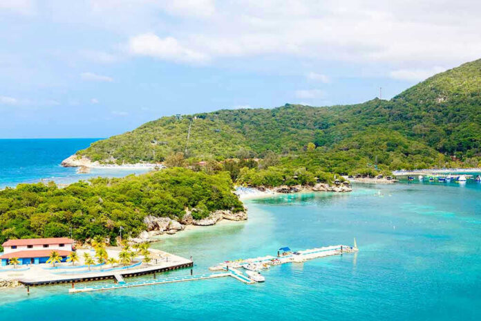 515128393 Tropical beach with docks and lush green hills.