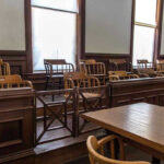 Jury Chaos Erupts: Mangione Trial Stuns Nation Empty jury box and table in courtroom