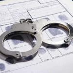 Jon Reep’s Career IMPLODES Amid Exploitation Allegations Handcuffs on fingerprint form with fingerprints visible