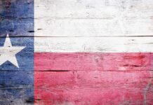 Texas flag displayed on a wooden background