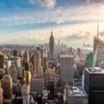 Adams Quits! NYC Mayor Race in Chaos Aerial view of New York City skyline featuring the Empire State Building at sunset