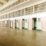 Death Row Monsters Face BRUTAL New Reality Interior view of a prison cell block with empty cells and security bars