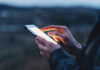 Violent Texts Rock State Race—Nobody Saw THIS Coming Person using a smartphone at dusk