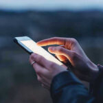 Person using a smartphone at dusk