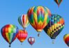 Balloons Invade! Smugglers Ground Airport Colorful hot air balloons floating in a clear blue sky