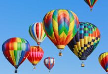 Balloons Invade! Smugglers Ground Airport Colorful hot air balloons floating in a clear blue sky