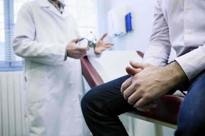 shutterstock_181677458.jpg A doctor in a white coat discussing with a patient sitting on an examination table