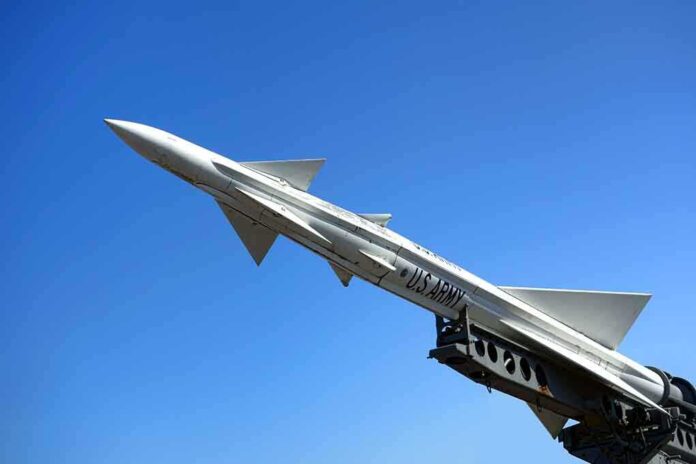 shutterstock_190114949.jpg A military missile pointed upwards against a clear blue sky