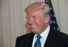 Shock 9th Circuit Ruling: Trump’s Power Upheld A smiling man in formal attire with an American flag in the background
