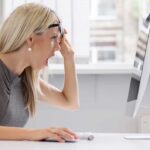 Campus Erupts Over Kirk Statue Controversy A woman with blonde hair showing a surprised expression while looking at a computer