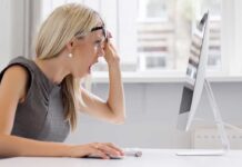 Campus Erupts Over Kirk Statue Controversy A woman with blonde hair showing a surprised expression while looking at a computer
