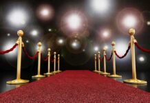 Rowling UNLEASHES on Watson—Hollywood Stunned A red carpet lined with gold stanchions and ropes under bright spotlights