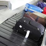 Air Traffic CHAOS Intensifies Various suitcases on an airport luggage carousel