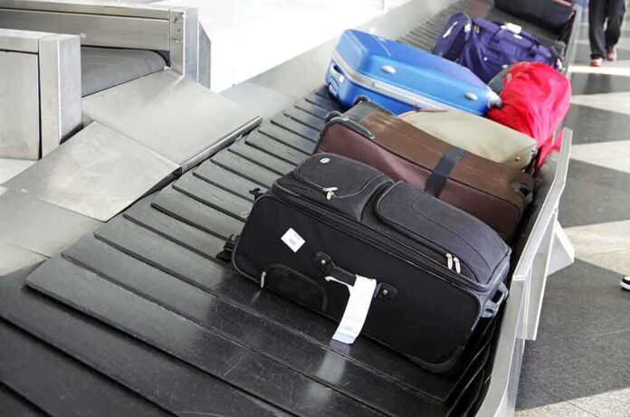 shutterstock_84943465.jpg Various suitcases on an airport luggage carousel