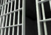 Close-up of prison cell bars.