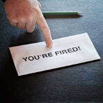 Envelope with YOURE FIRED! and pointing finger.