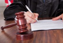 Unbelievable: Sandwich, Not Assault! A judge signing a legal document with a gavel in the foreground