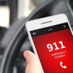 Kid’s Brave Move Saves His Dad A smartphone displaying the emergency number 911 while held in a persons hand inside a car