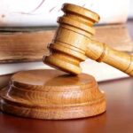 Federal Court RUSHES DIDDY Appeal — Victims Outraged A wooden gavel resting on a circular base with law books in the background
