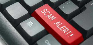 Close-up of keyboard with red SCAM ALERT key.