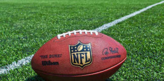 NFL football on a green field.
