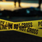 Police tape marking a crime scene at night.