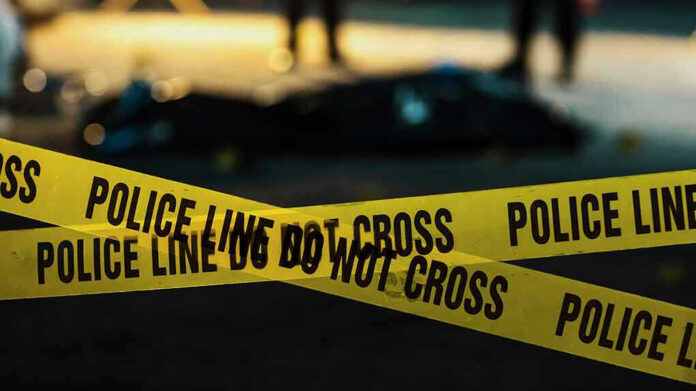 2230640045 Police tape marking a crime scene at night.