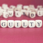 Putin GUILTY Of Chemical Murder On British Soil Dice spelling GUILTY on a red surface.
