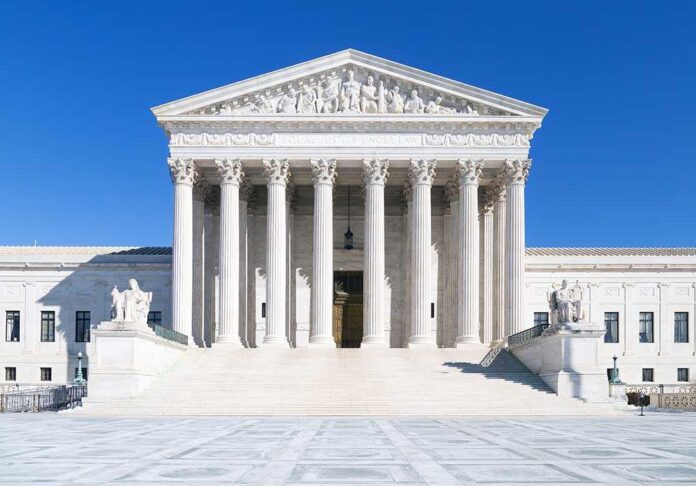 shutterstock_179112365.jpg The Supreme Court building featuring marble columns and a clear blue sky
