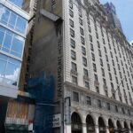 Facade of the Paramount Hotel alongside modern buildings under construction