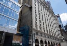 Facade of the Paramount Hotel alongside modern buildings under construction