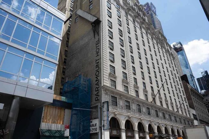Facade of the Paramount Hotel alongside modern buildings under construction