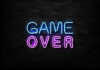 Game Over neon sign on brick wall.