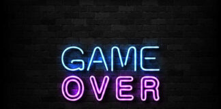 Game Over neon sign on brick wall.