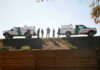 Border Patrol vehicles and agents on a ridge.