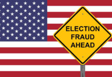 Yellow sign reading Election Fraud Ahead with American flag.