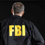 FBI Agent’s ID Stolen—Death Threats Unleashed FBI agent with back facing the camera.