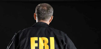 FBI agent with back facing the camera.