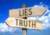 STUNNING Betrayal — TOP Leader Exposes Democrat Lies Signs pointing to Lies and Truth against sky.