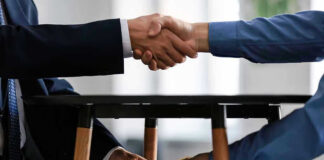 Handshake and exchange of money under the table.