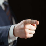 Border Czar Declares WAR Person pointing with finger, wearing a suit.