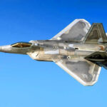 Stealth Bomber Fleet SLASHED—America Dangerously Exposed Fighter jet in flight against a clear blue sky.