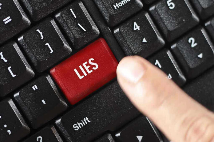 529290325 Finger pressing LIES key on keyboard.