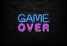 Game Over neon sign on brick wall.