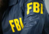 Tucker’s MILLIONS Vanished — FBI Scrambling Now FBI jacket with yellow letters.