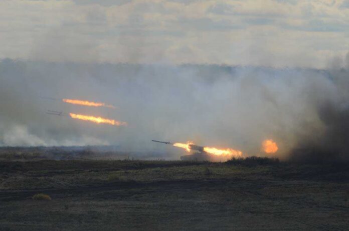 shutterstock_86562808.jpg A tank firing in a smoky battlefield during a military exercise