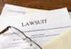 SHOCKING Glock Lawsuit: SO MUCH At Stake Documents labeled Lawsuit with glasses on top.