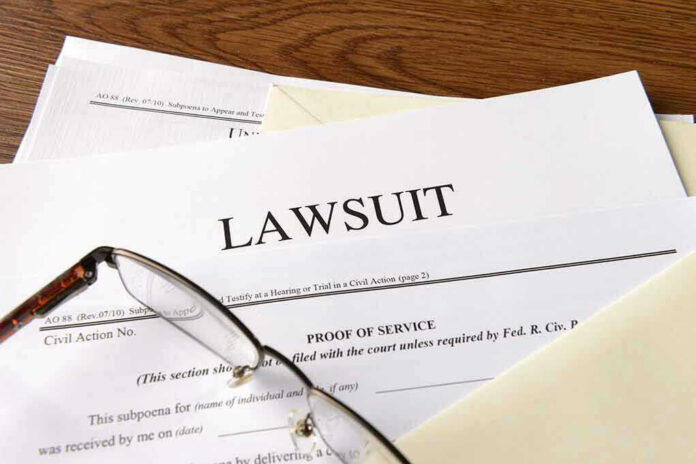 334984976 Documents labeled Lawsuit with glasses on top.