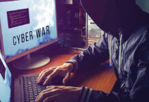 New Cyber Branch Plan Raises Big Questions Hacker typing at desk with Cyber War screen.