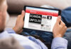 MASSIVE NVIDIA Smuggling SCANDAL Erupts Person reading tablet with headline Scandal Unfolds.